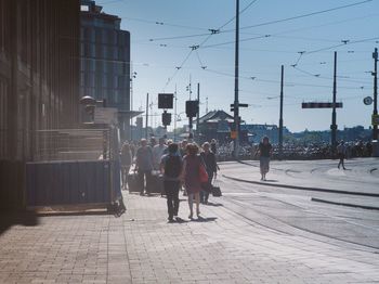 People in city against sky