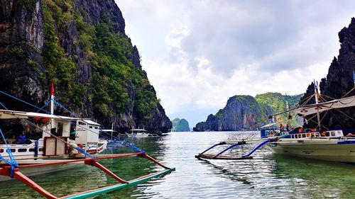 Boats moored in sea against sky