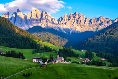 Scenic view of field and mountains against sky