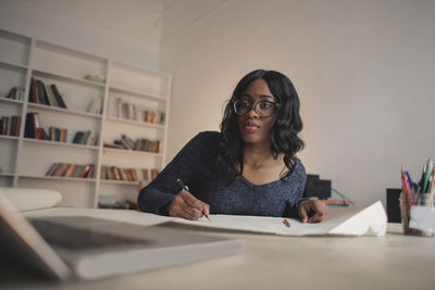 Young woman works in a creative studio