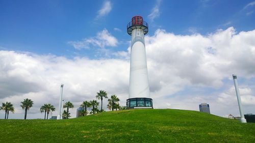 Low angle view of lighthouse against cloudy sky