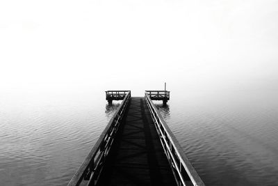 Pier over sea against clear sky