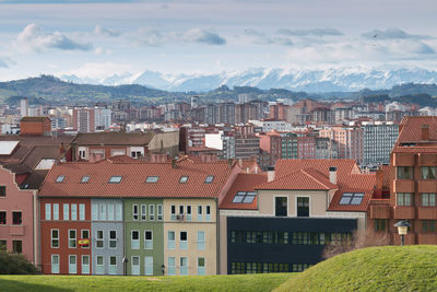 Houses in town against sky