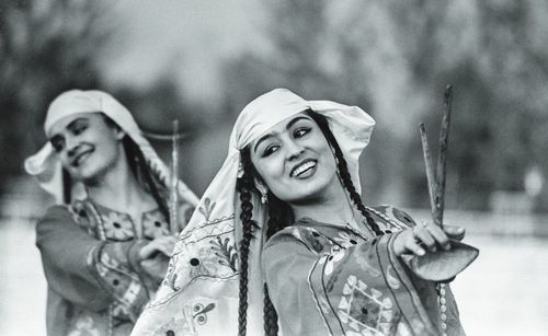 Smiling young woman dancing outdoors