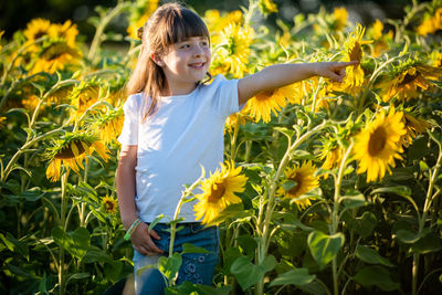 Girl standing in front of sunflower