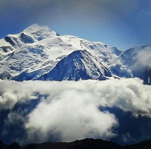 Scenic view of snow covered mountains against sky