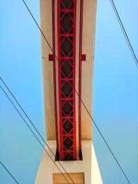 Low angle view of suspension bridge against clear blue sky