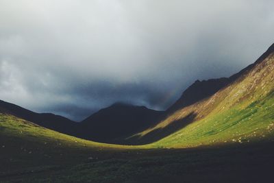 Scenic view of mountains against cloudy sky