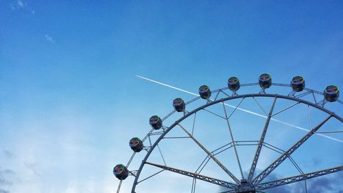 High section of ferris wheel against clear blue sky