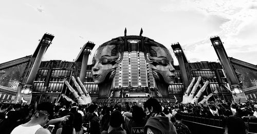 Group of people in front of building against sky