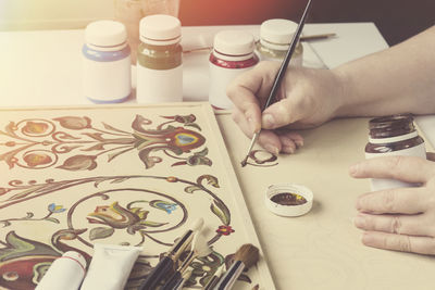 High angle view of woman hand on table