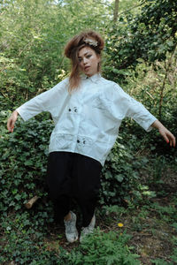 Portrait of teenage girl standing in forest