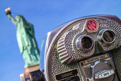 Statue of liberty with coin-operated binoculars in foreground