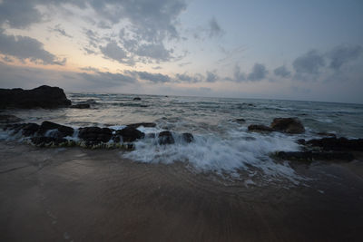 Scenic view of sea against cloudy sky