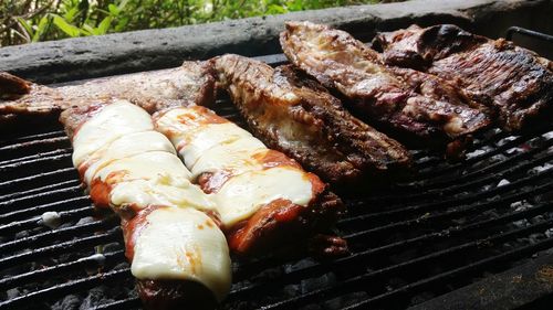 Close-up of meat on barbecue grill in yard