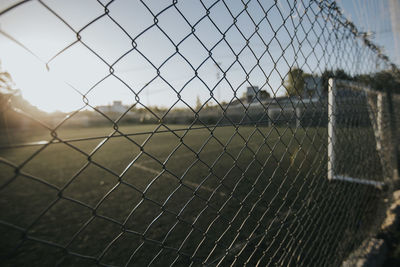 Close-up of chainlink fence against sky