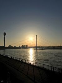 View of bridge in city at sunset