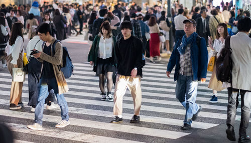 Group of people walking on city street