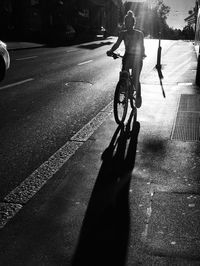 Man riding bicycle on road