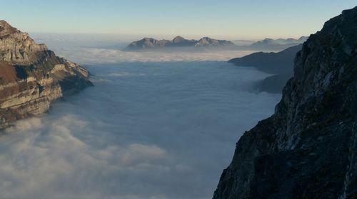 Panoramic view of sea and mountains against sky