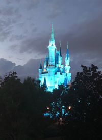 Low angle view of illuminated building against sky at night