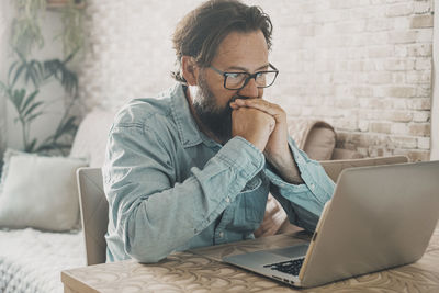 Young man using laptop at home