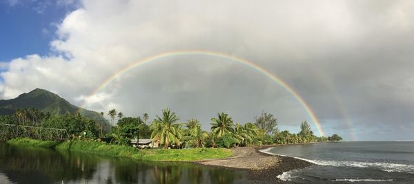 Panoramic shot of rainbow over sea against sky