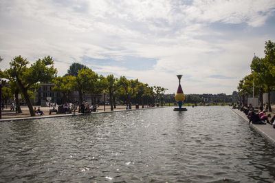 Man in water against sky