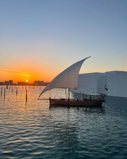 Sunset and boat on the background near the louvre abu dhabi