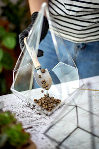 Midsection of person preparing food on table