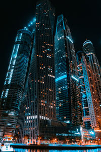 Low angle view of skyscrapers lit up at night