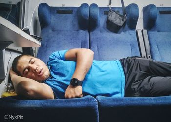 Boy sleeping on sofa at home