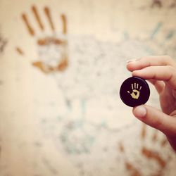 Close-up of cropped hand holding camera