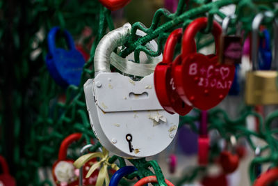 Close-up of padlocks hanging on metal wire