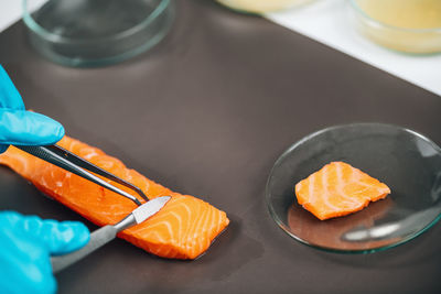 Food safety and quality testing salmon fish. laboratory technician taking salmon fish sample.