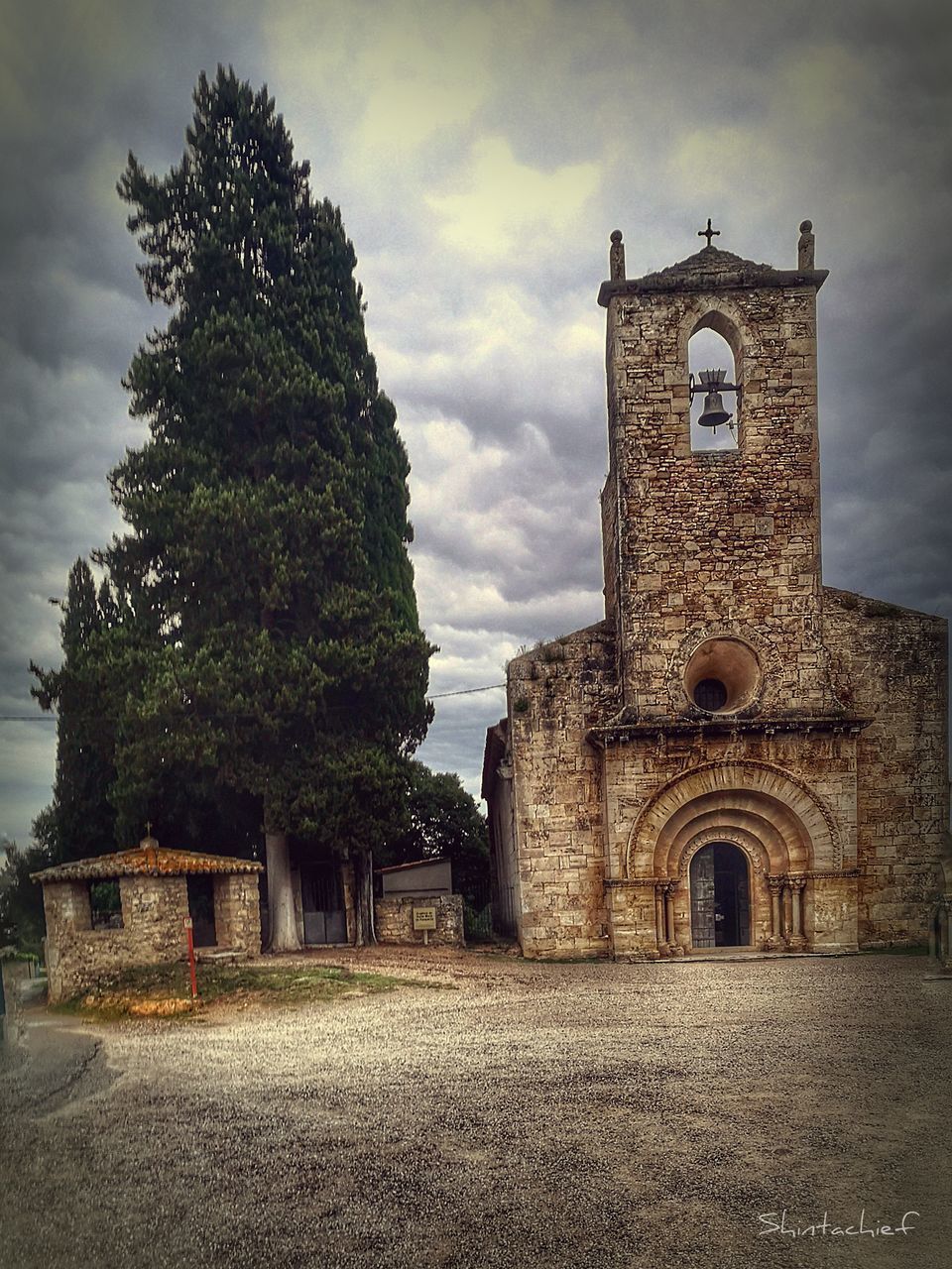 CASTLE BY TREE AGAINST SKY