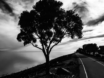 Empty road against cloudy sky