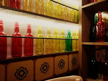 Multi colored bottles in shelf