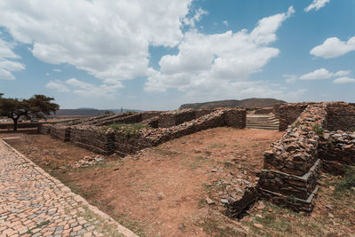 View of old ruin on field against sky