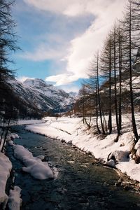 Scenic view of landscape against sky during winter