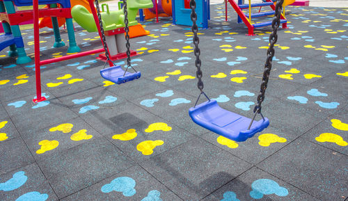 High angle view of yellow playground on footpath