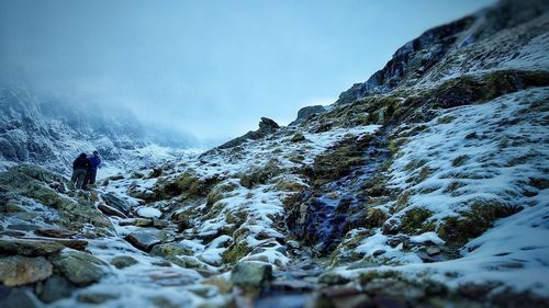 Scenic view of snow covered mountains against sky