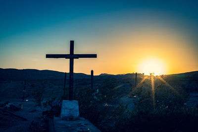 Scenic view of cross against sky during sunset
