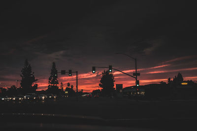 Illuminated road against sky at night