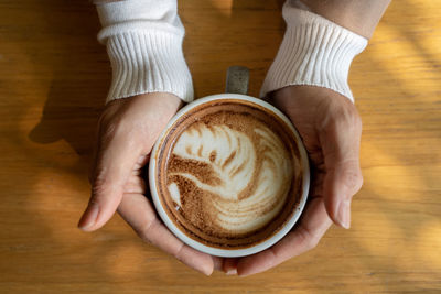 High angle view of coffee cup on table