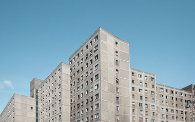 Low angle view of buildings against clear blue sky