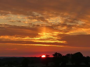 Silhouette landscape against scenic sky