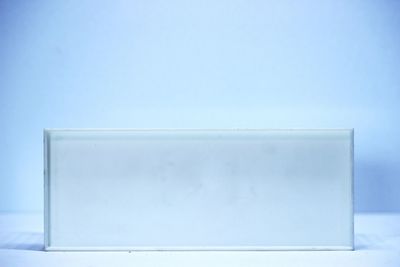 Close-up of snow against blue sky