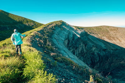 Rear view of man walking on mountain