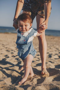 Full length of cute girl standing at beach